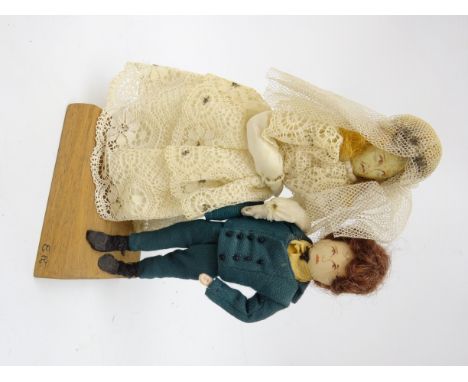 Edith Russell group of two Dickensian dolls with painted facial features and soft bodies, manuscript details under the mahoga