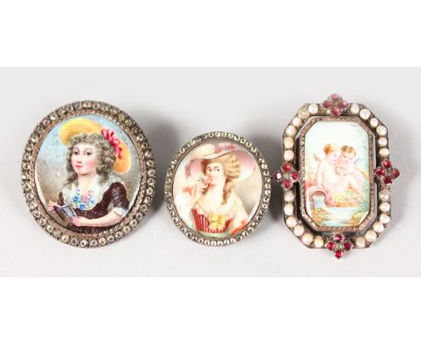 THREE LOVELY FRENCH ENAMEL BROOCHES, one with two cupids in a seed pearl frame, and two others of ladies with brilliant set f