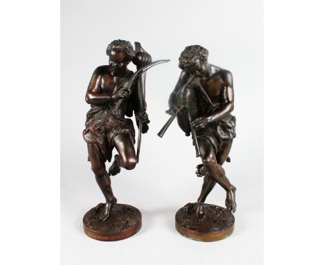 A GOOD PAIR OF 19th CENTURY FRENCH BRONZES OF CLASSICAL MEN playing musical instruments, on circular bases. 14ins high.