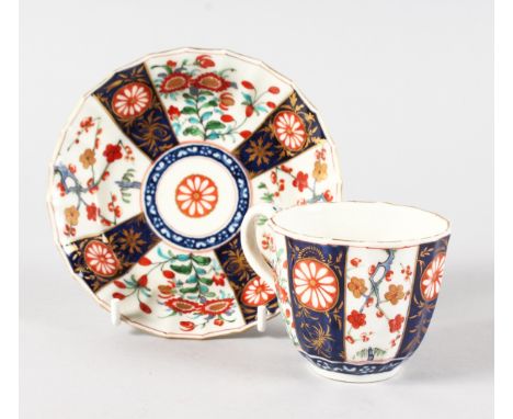 AN 18TH CENTURY WORCESTER FACETTED COFFEE CUP AND SAUCER painted in kakiemon style.