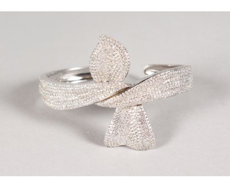 A SILVER AND PAVE SET CRYSTAL BANGLE.