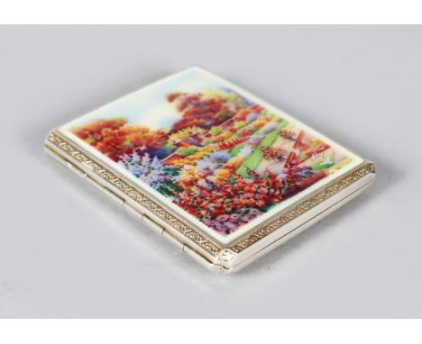 AN EROTIC SILVER CIGARETTE CASE, Birmingham 1928, set with an enamel plaque of a garden.