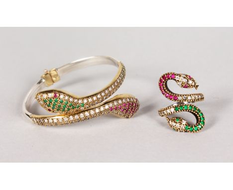 A SILVER AND SILVER GILT RUBY AND EMERALD SNAKE BRACELET AND RING.