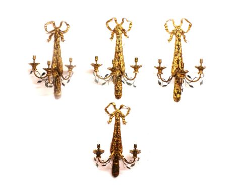 A SUPERB SET OF OF FOUR 19th CENTURY TOLE WARE GILDED THREE LIGHT WALL SCONCES with ribbon motifs, acorn and acanthus decorat