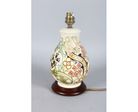 A MODERN MOORCROFT POTTERY LAMP, converted to electricity, on a wooden base.10ins high.