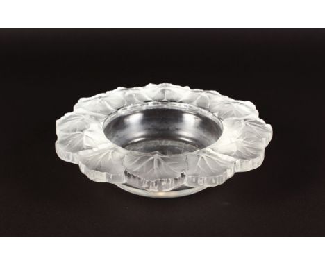 A LALIQUE CIRCULAR DISH, the border with frosted flowers, etched R. Lalique, France. 21cms diameter.