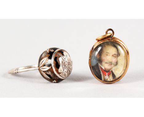 A SILVER AND ENAMEL RING and a LOCKET (2).