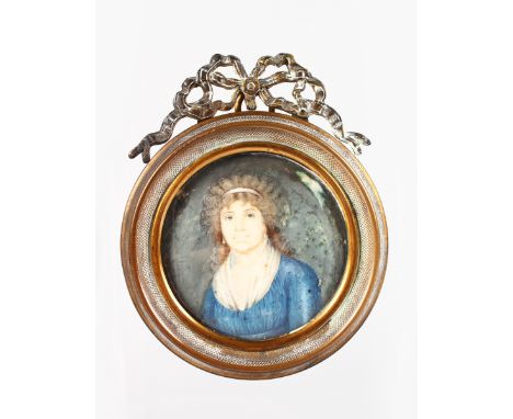 19th CENTURY FRENCH SCHOOL, A CIRCULAR PORTRAIT OF A LADY wearing a blue dress. 6cms diameter in a gilt metal frame with ribb