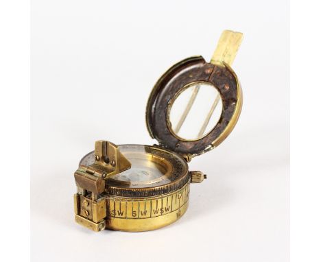 A BRASS CIRCULAR TRAVELLING COMPASS/. 5.5cms diameter.