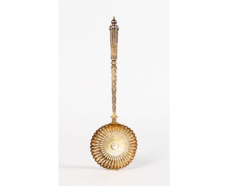 A GOOD PIERCED SILVER GILT LADLE, possibly Russian. 20cms long.
