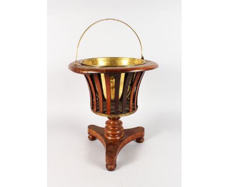 A DUTCH MAHOGANY BASKET ONSTAND with brass liner on tripod base. 17ins high.