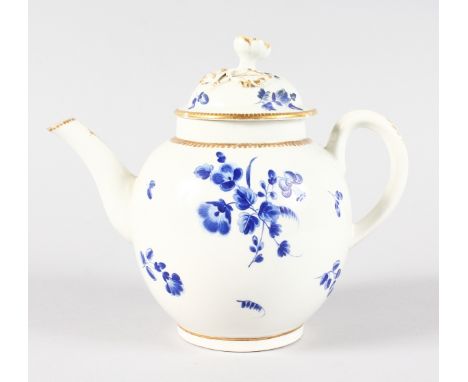 AN 18TH CENTURY WORCESTER TEAPOT AND COVER painted with dry blue flowers.