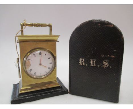 A leather cased travelling clock  