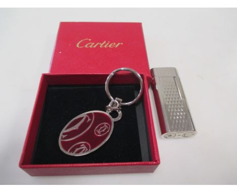 A Tiffany cigarette lighter and a Cartier pendant key ring - Aucthenticity is in dispute