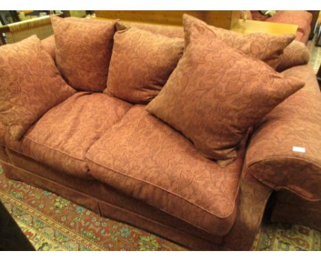 A Wesley Barrell red upholstered two seater sofa and ottoman  