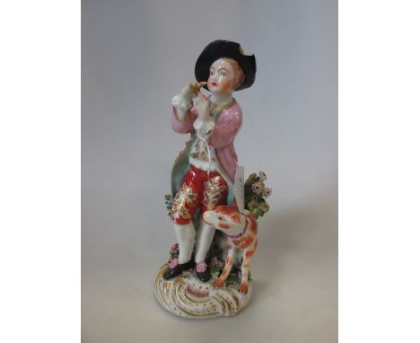 A patch marked Derby figure of a clarinettist, 27.5cm (7 in) high  There are chips to his hat the bocages and he has lost his