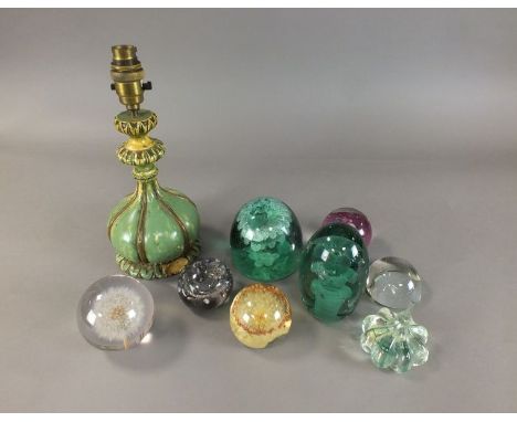 A collection of glass paperweights to include a tall Victorian green glass dumps, an example inset with a Durham Light Infant