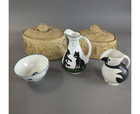 Two 19th century caneware game tureen dishes with liners and covers, the largest 29cm long, a Louis Wain jug with decoration 