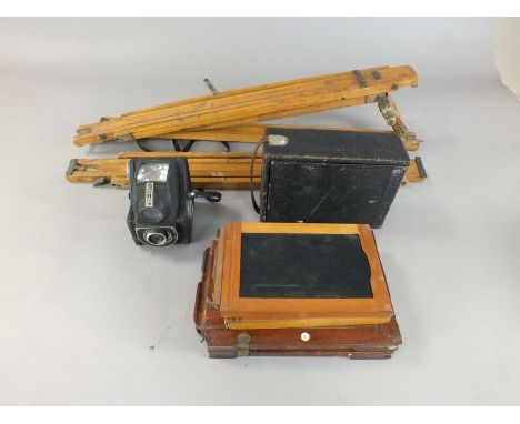A Kodak bellows camera, 18 x 13cm, a pair of dark slides, 17 x 11cm, a tripod, a pair of associated mahogany double dark slid