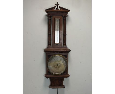 A Victorian oak cased aneroid barometer by Short and Mason with 10” silvered dial below a barometer in architectural case wit