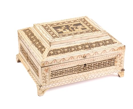 An early 19th century Napoleonic prisoner of war carved bone table box, with fret carved panels and engraved decoration, the 