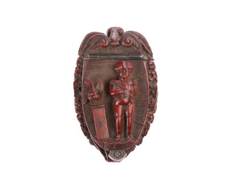 Of Napoleonic interest, an early 19th carved coquilla nut Bugbear snuff box, the hinged lid carved in relief with a figure of