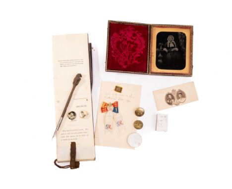 A small fragment of the pall (coffin cover) of the late Queen Victoria, attached to a note detailing its provenance, a small 