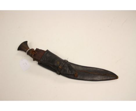 WW2 era Gurhka Kukri knife. 32cm steel blade with some engraved decoration. Wooden grip. Black leather scabbard. Tip of scabb