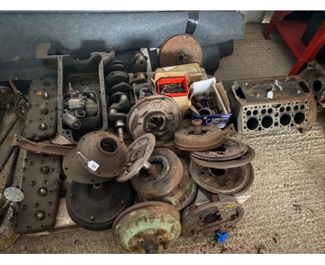 A collection of Ford V8 engine components, and various brake and other mechanical parts.