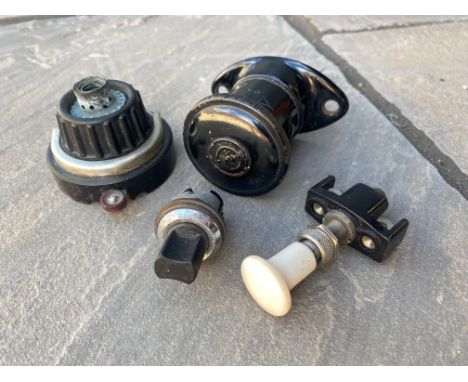 A Lucas type D20 dash lamp, a Smiths cigarette lighter and two switches.
