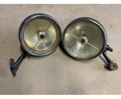 A pair of Lucas L165S headlamps on brackets, fitted previously to a Bugatti and an I.C.M.E manual, 1962 edition. 