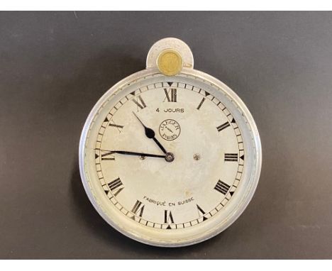A Jaeger eight day car clock with top wind. 