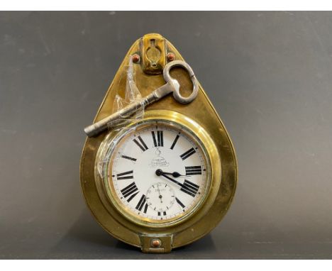 A Smith and Son brass framed travel car clock with key. 