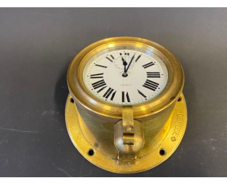 A Doxa rim-wind eight day car clock with sloping mount for Veteran or Edwardian car. 