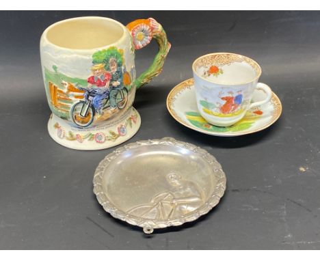 A Crown Devon musical jug depicting a couple on a tandem, a cup and saucer depicting cyclists and a trinket dish. 