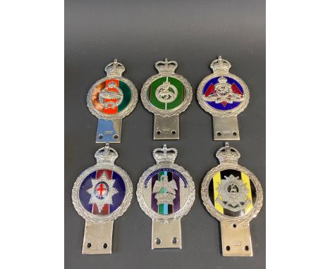 Five Gaunt enamel regimental car badges and one other. 