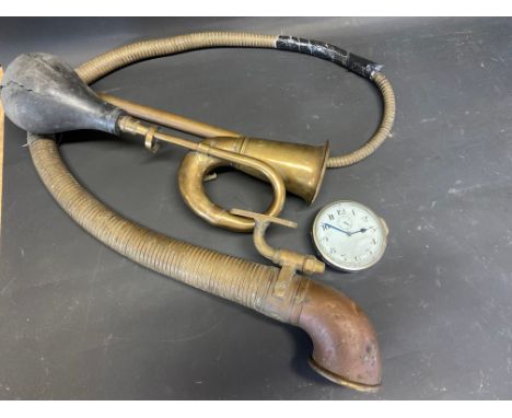An eight day car clock, a brass boa constrictor partial horn and one other. 