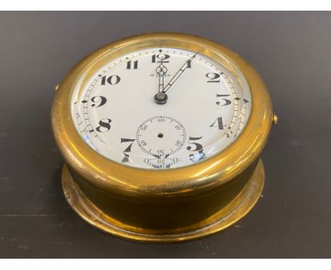 A large Edwardian brass sloping backed eight day car clock. 