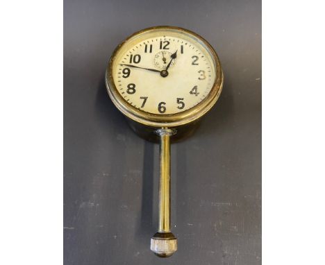 A brass eight day car clock with secondary dial and bottom wind. 