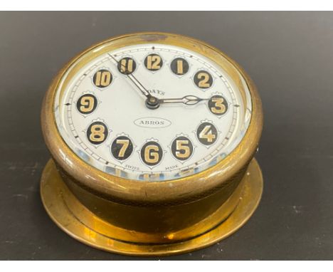 An Edwardian brass sloping backed eight day car clock. 