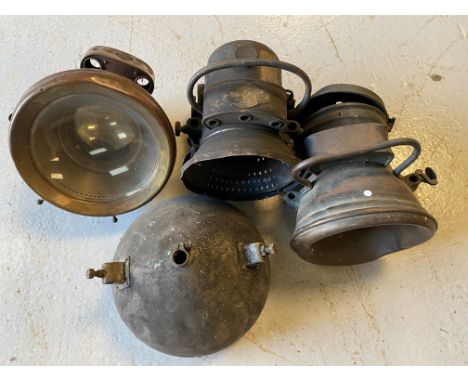 Four pre-war headlights including an H &amp; B self-generating lamp. 