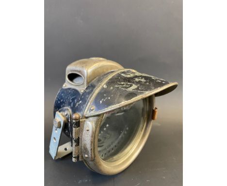 A Lucas King of The Road motorcycle headlamp with peak.