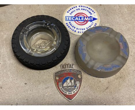 A Goodyear tyre ashtray, a Regent glass ashtray, a Tecalemit coaster and a Kuwait International Touring and Automobile Club b