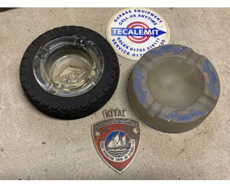 A Goodyear tyre ashtray, a Regent glass ashtray, a Tecalemit coaster and a Kuwait International Touring and Automobile Club b