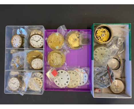 Three small trays of car clock parts. 