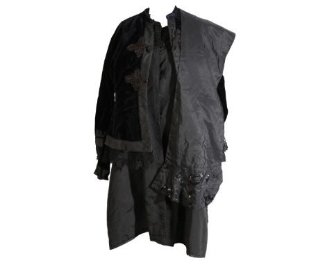 AN EDWARDIAN BEADED MOURNING COAT the collar and cuffs edged with lace and beadwork, the centre back with a beadwork and tass