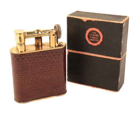 A BRASS AND CROCODILE SKIN TABLE LIGHTER patent no. 286838/27, in the original cardboard case, retailed by "The Classic Table