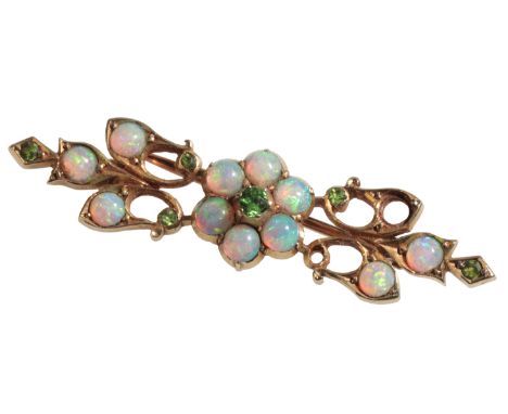 A GOLD COLOURED METAL, OPAL &amp; DEMANTOID GARNET BROOCH of Art Nouveau design, the central flowerhead set with central garn