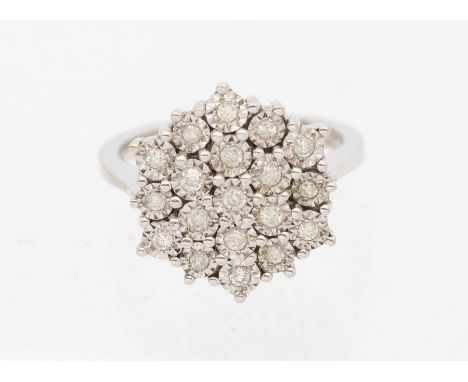 A diamond set 9ct white gold cluster ring, comprising a circular setting, set with small illusion set diamonds, setting appro