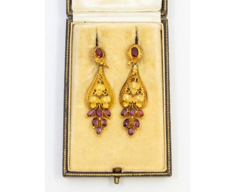 A pair of early Victorian garnet and paste set gold drop earrings, comprising an oval red paste top within a border of applie